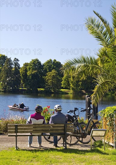 Cyclist on the Ruhr Valley Cycle Path with palm trees