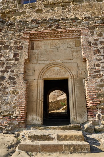 Entrance portal with old Georgian inscription and relief panels with animal motifs