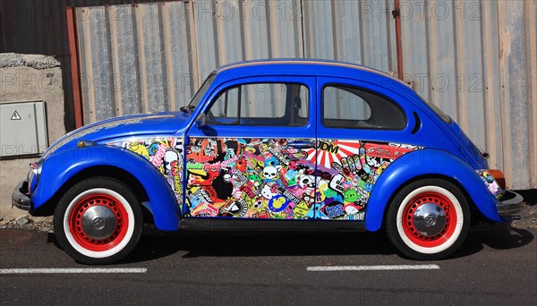 Blue VW Beetle with many stickers