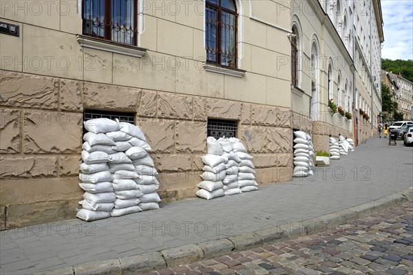 Sandbags on house facade in Lviv