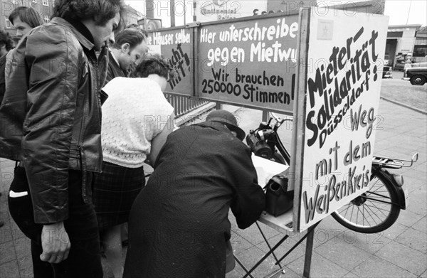 Tenants protest with a collection of signatures