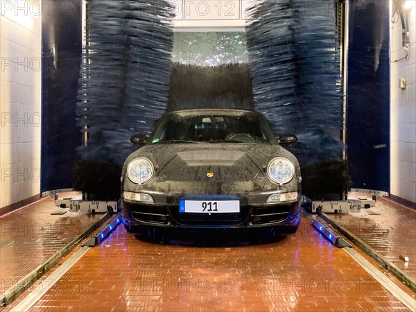 Porsche 911 sports car in a car wash
