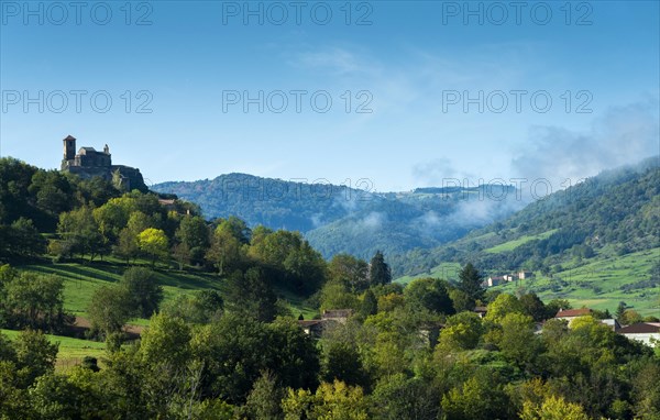 Saint-Ilpize castle perched on a volcanic peak above river Allier. Haute-Loire department. Auvergne-Rhone-Alpes. France