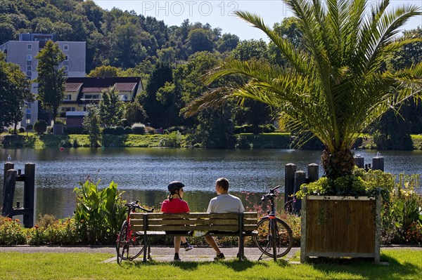 Cyclist on the Ruhr Valley Cycle Path with palm trees