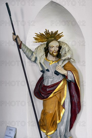 Figure of a saint with lamb and wreath