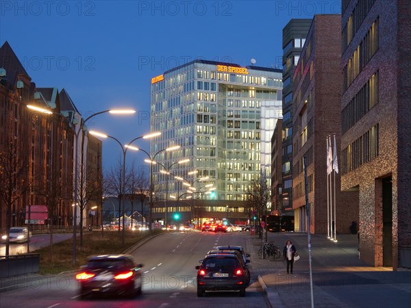 The brightly lit publishing house Der Spiegel at dusk