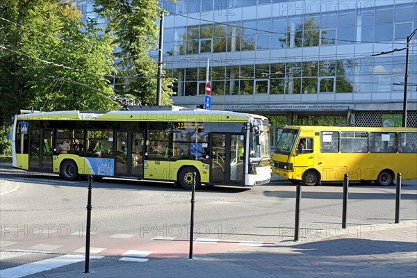 Modern trolley bus and old bus