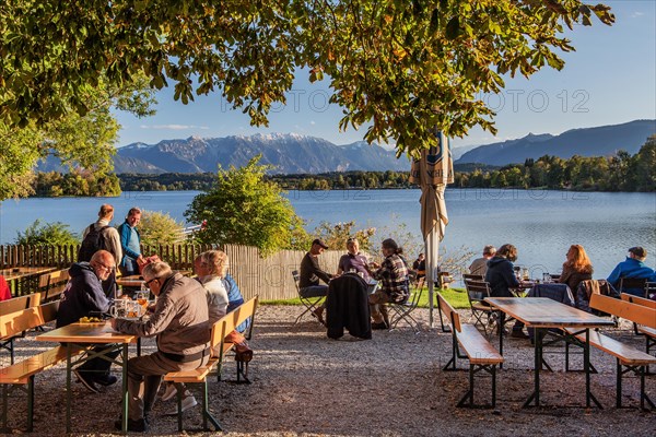 Beer garden at Staffelsee with Ester Mountains in the evening sun