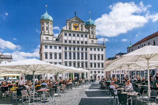 Restaurant terraces on the town hall square with town hall