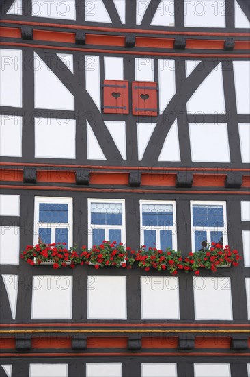 Idyllic house wall with shutters and flower decoration from the historic town hall