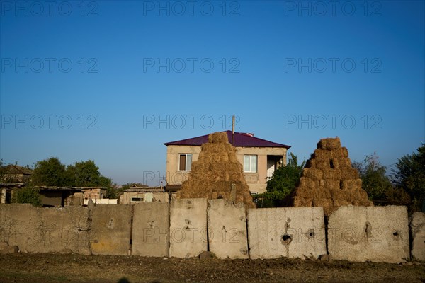 Farmhouse with hay stacks and concrete slab perimeter