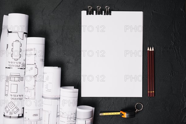 Blank paper with blueprints on table