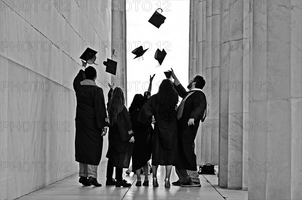 College students celebrate their graduation at the Lincoln Memorial on the National Mall