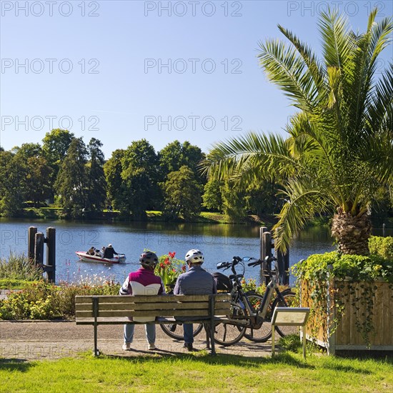 Cyclist on the Ruhr Valley Cycle Path with palm trees