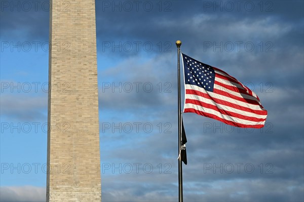 Washington Monument on the National Mall next to US Flag
