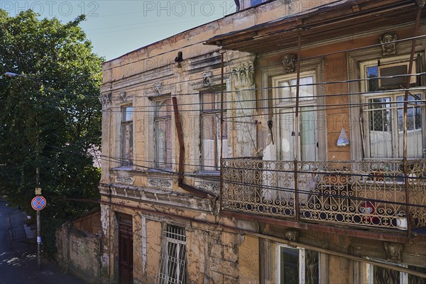 Old house in need of renovation with balcony