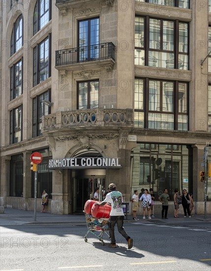 Man collects small metal in shopping trolley