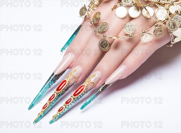 Long beautiful manicure on the fingers of turquoise and red. Nails design. Picture taken in the studio on a white background. Isolate object