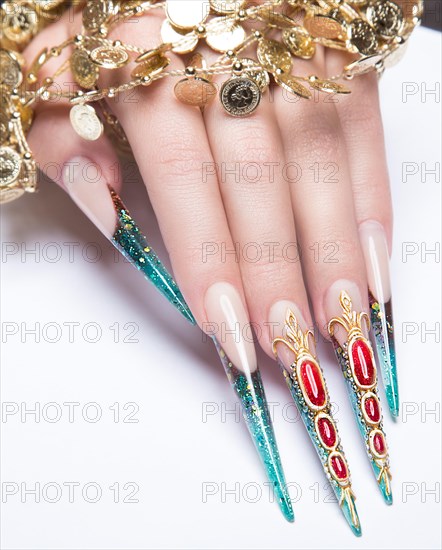 Long beautiful manicure on the fingers of turquoise and red. Nails design. Picture taken in the studio on a white background. Isolate object