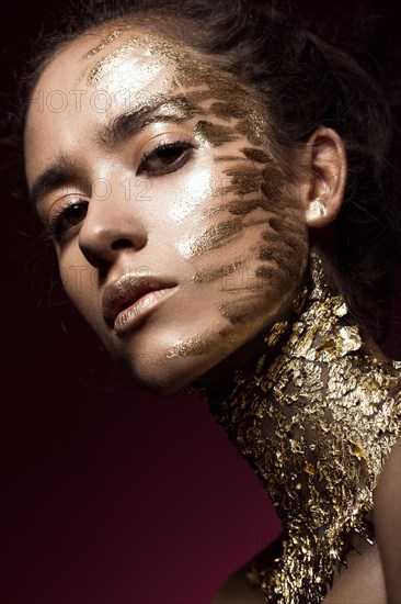 Beautyful girl with gold glitter on her face.Art image beauty face. Picture taken in the studio