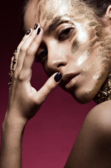 Beautyful girl with gold glitter on her face.Art image beauty face. Picture taken in the studio