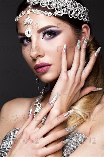 Beautiful girl in the image of the Arab bride with expensive jewelry