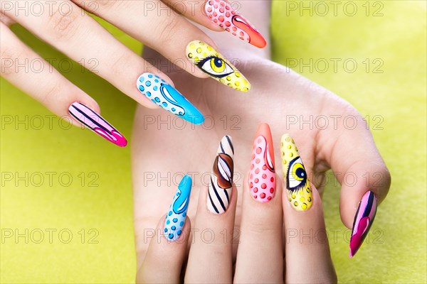 Long beautiful manicure in pop-art style on female fingers. Nails design. Close-up