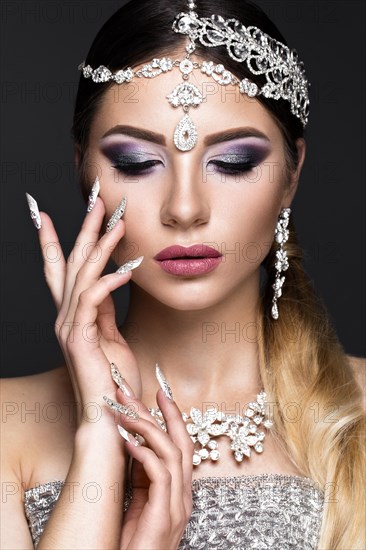 Beautiful girl in the image of the Arab bride with expensive jewelry