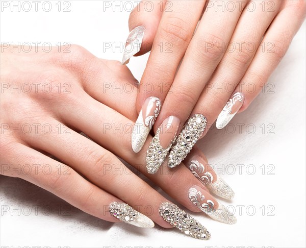 Beautifil wedding manicure for the bride in gentle tones with rhinestone. Nail Design. Close-up