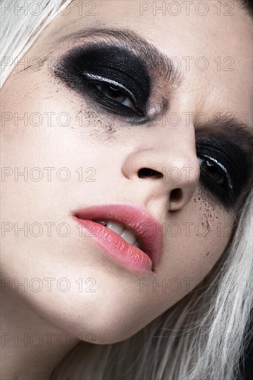 Beautiful blond girl with dark smokey makeup. beauty face. Photos shot in studio