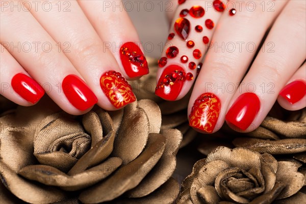 Shot beautiful manicure with rhinestones on female fingers. Nails design. Close-up. Picture taken in the studio