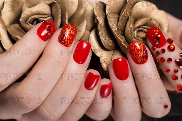 Shot beautiful manicure with rhinestones on female fingers. Nails design. Close-up. Picture taken in the studio