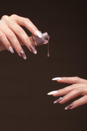 Beautiful classic manicure on female hand with nail polish. Close-up. Picture taken in the studio