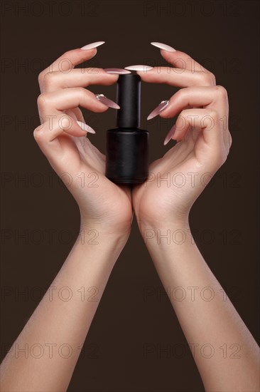 Beautiful classic manicure on female hand with nail polish. Close-up. Picture taken in the studio