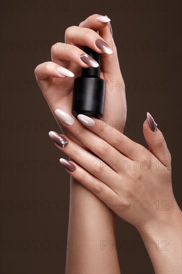 Beautiful classic manicure on female hand with nail polish. Close-up. Picture taken in the studio