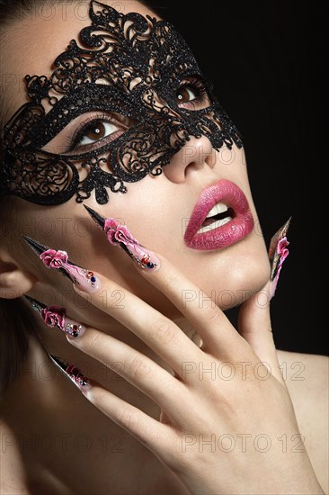 Beautiful girl with long nails and sensual lips. Portrait shot in the studio on a black background.Beauty face