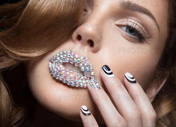 Beautiful girl with bright nails and lips of crystals