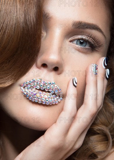 Beautiful girl with bright nails and lips of crystals