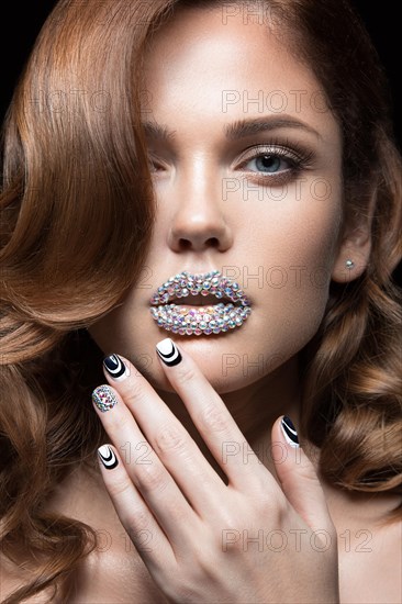 Beautiful girl with bright nails and lips of crystals