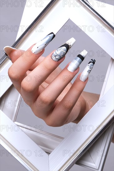 Creative gradient design of nails on female hands. Art manicure. Photo taken in studio