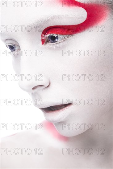Art fashion girl with white skin and red paint on the face. Creative art beauty. Picture taken in the studio on a white background