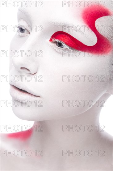 Art fashion girl with white skin and red paint on the face. Creative art beauty. Picture taken in the studio on a white background