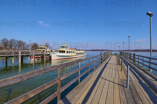 Lake Ciemsee with pier and excursion boat