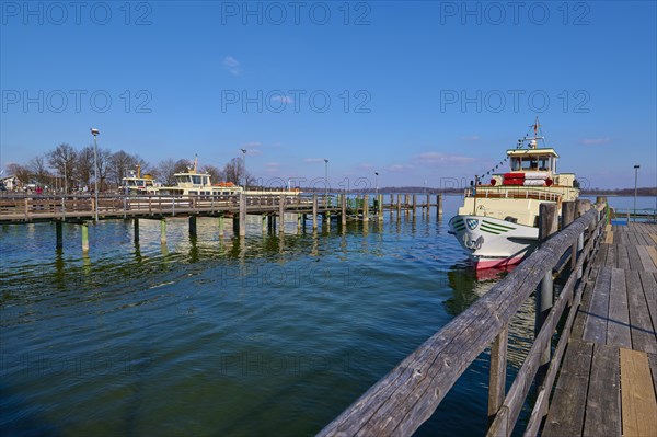 Lake Ciemsee with pier and excursion boat