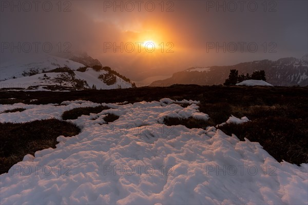 Sunset on the Niederhorn with cloudy sky