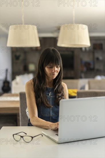 Business woman working from home using her laptop
