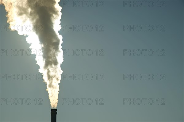 Smoking chimney of a modern biomass-fuelled combined heat and power plant