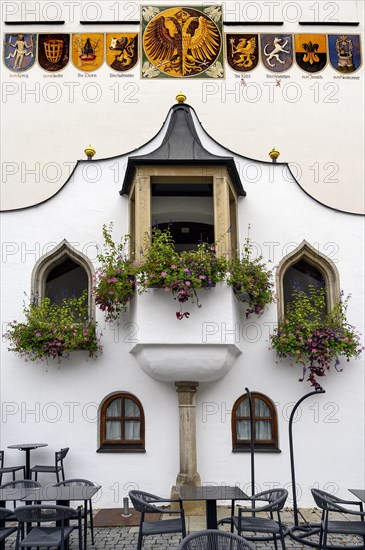 Coat of arms and floral decorations on the lancet windows at the town hall in Kempten