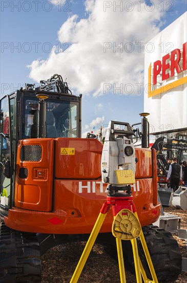 Surveying instrument in front of construction machine