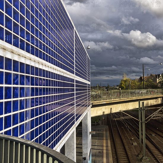 Station building made of blue glass blocks and exposed concrete